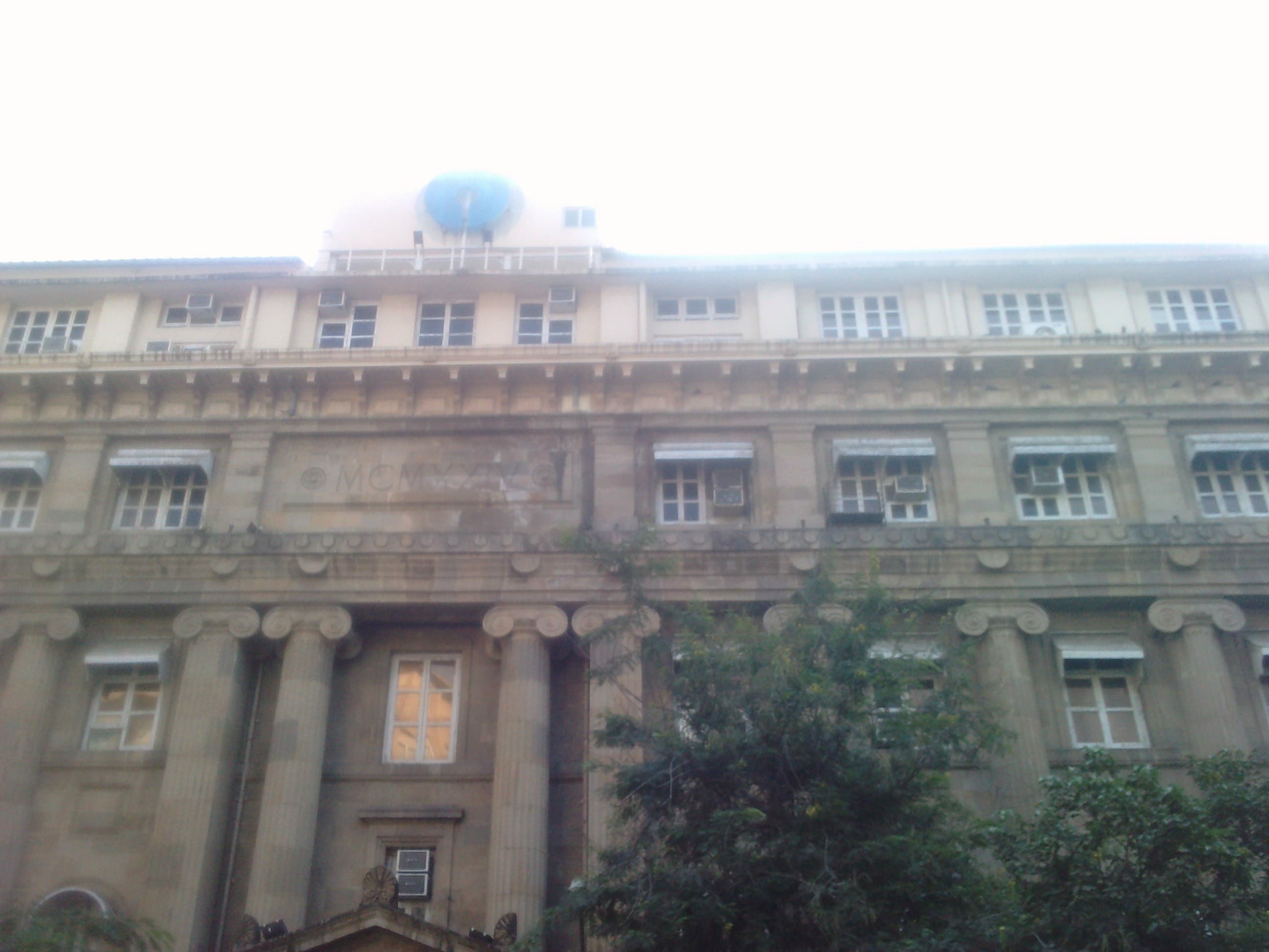 The colonnaded stone facade of the State Bank of India's main branch building in Mumbai